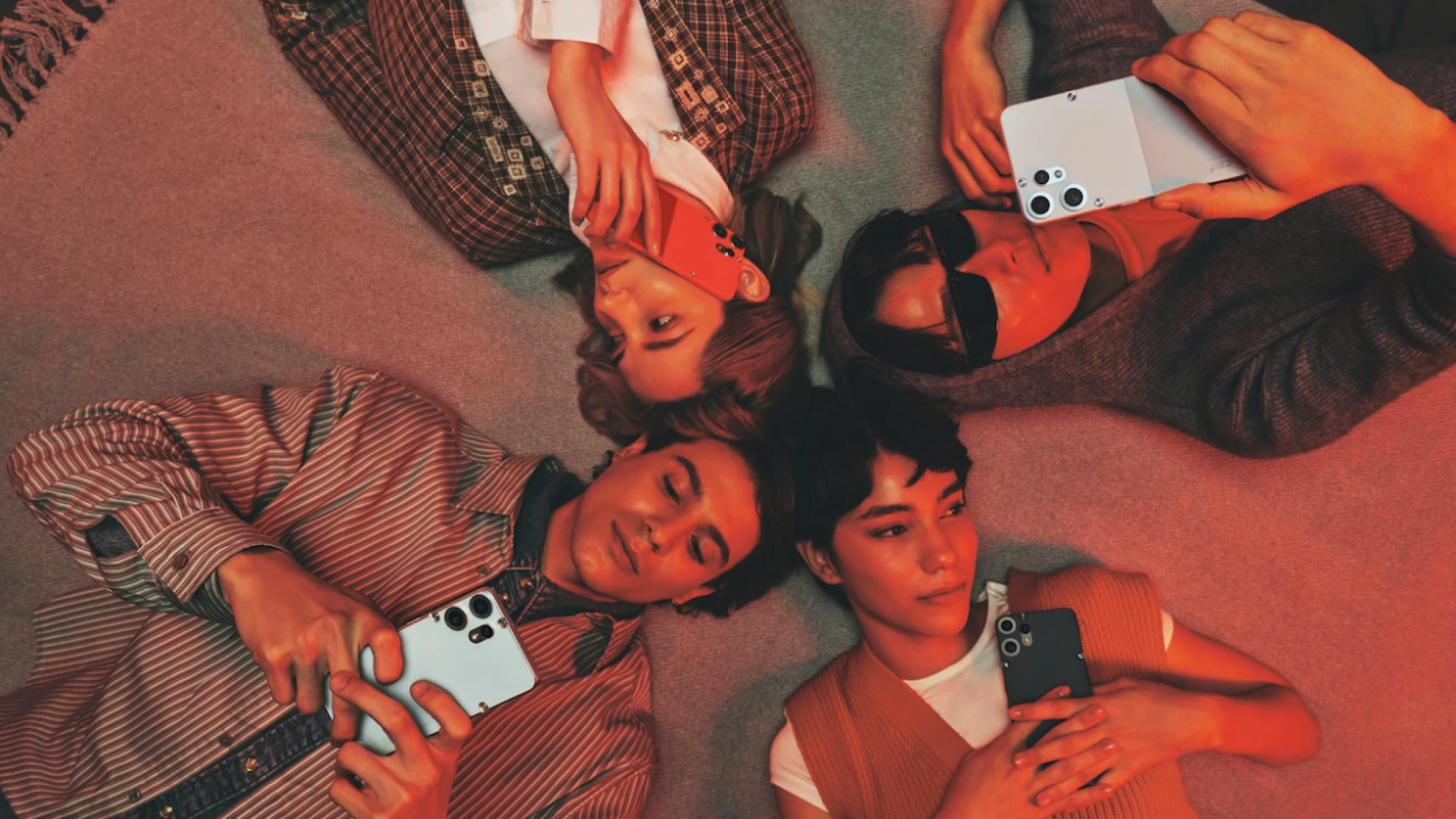people laying in a circle and using nothing cmf phone 2 pro
